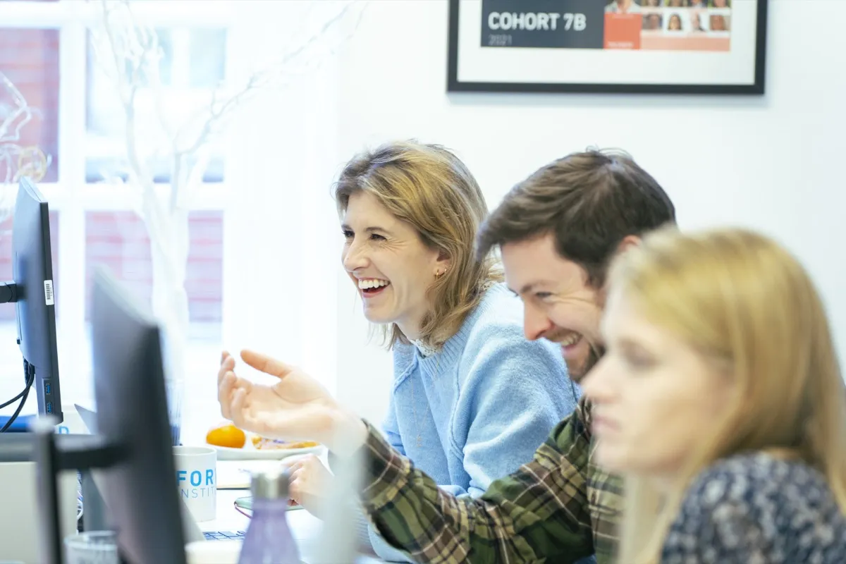 Workshop participants laughing during a session