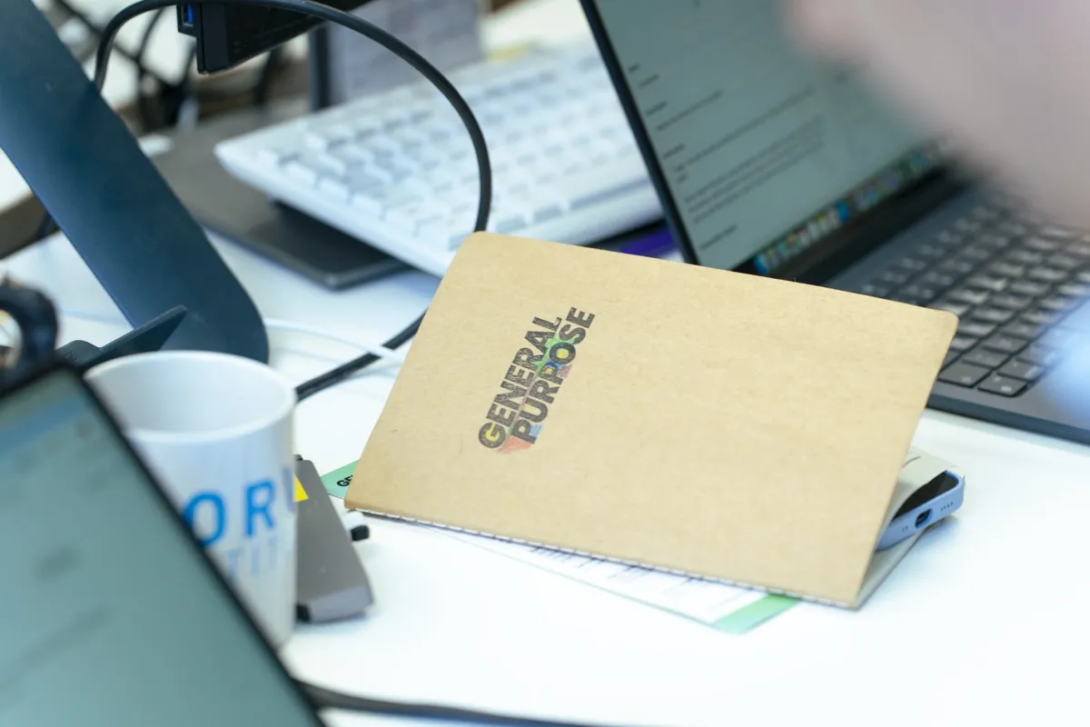 General Purpose branded notebook on a workshop desk
